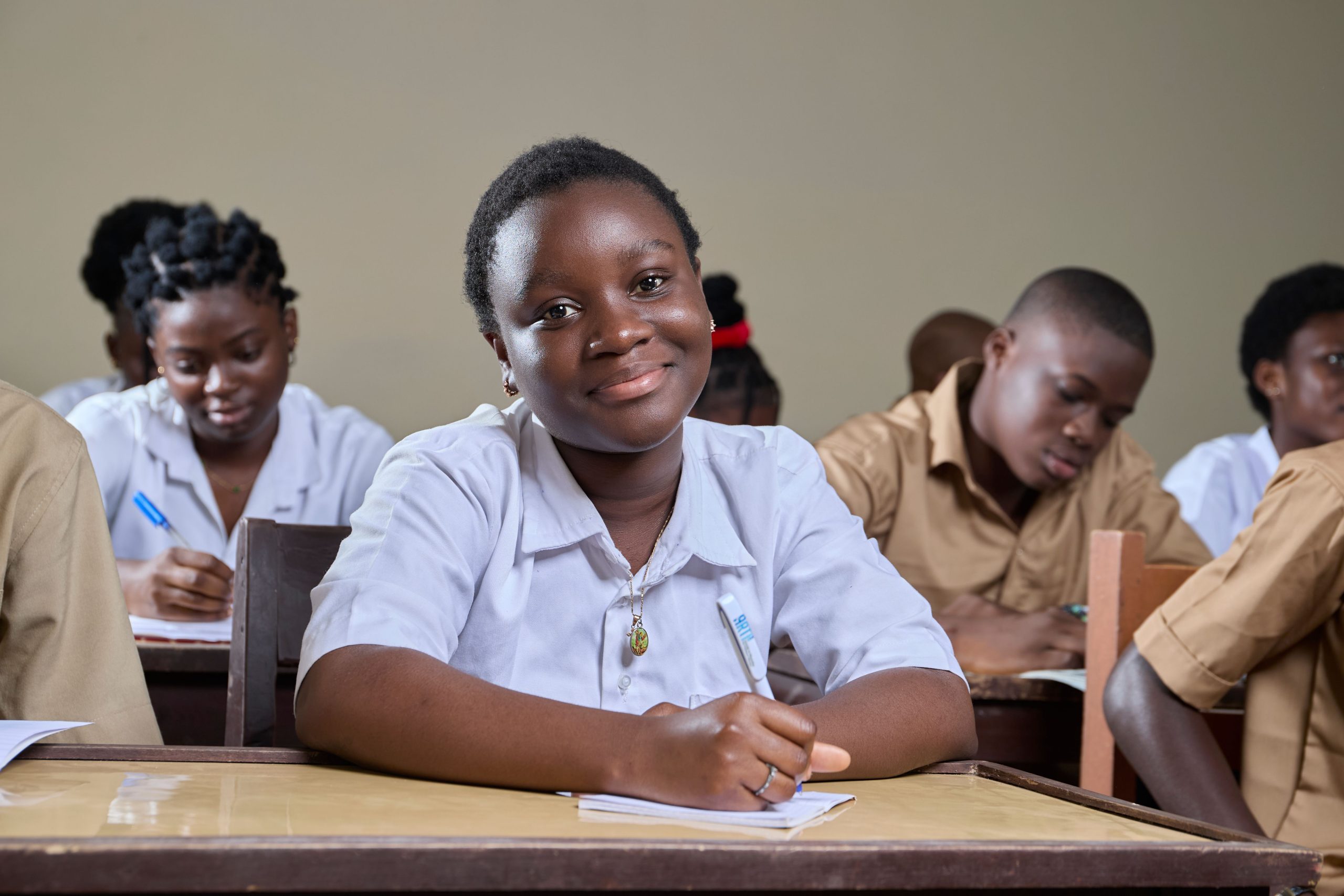 Home Engaged students studying in a diverse classroom environment, showcasing educational commitment.